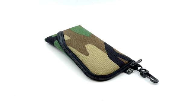 A Small Ghost Whale Pouch in Beaver Camo (green, brown, tan, and black camoflauge pattern).